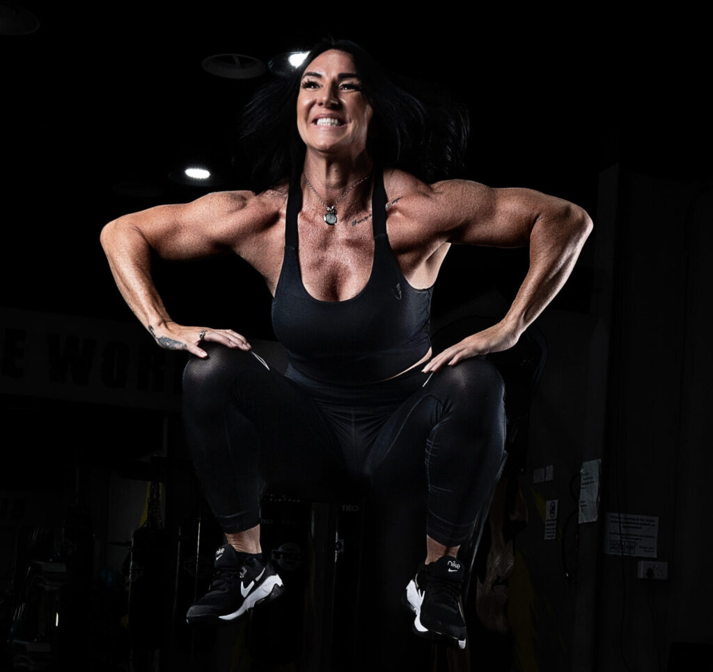 Focused woman engaging in an intense workout at MMS Fitness gym, using state-of-the-art fitness equipment.